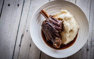 Cooked Lamb shank with buttery mash and gravy. 