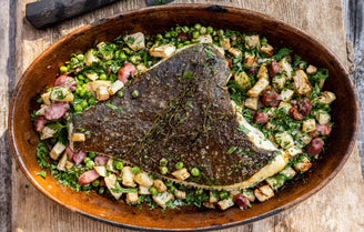 Whole cooked turbot on a bed of Bacon, Celeriac, Peas & Parsley