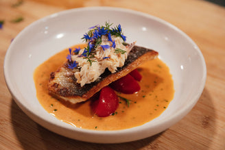 Wild Seabass Fillet on a bed of Isle of White Tomatoes in a Crab and Lemon Grass Sauce