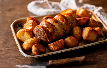 A cooked properly free range boneless turkey leg with roast potatoes