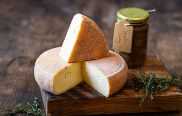 A whole wheel of white wood dairy St Helena raw milk cheese, with a jar of chutney