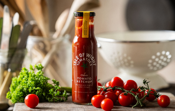 A bottle of Isle of Wight, Classic Tomato Ketchup with tomatoes and parsley.
