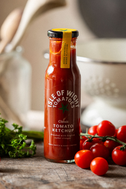 A bottle of Isle of Wight, Classic Tomato Ketchup with tomatoes and parsley.