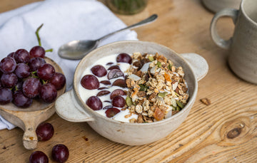 riverford natural fat free yogurt in a bowl with granola and grapes