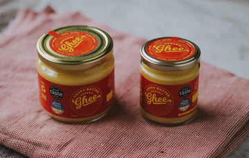 Jar of Happy Butter Organic Grassfed Ghee, a cooking oil from organic butter, ideal for high-heat cooking and dairy-free diets.