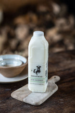 A bottle of Hollis Mead Organic Semi skimmed milk on a table