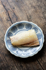 A filet of British caught smoked haddock on a plate