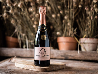 A bottle of Swanaford Brut Rosé sparkling pink wine.